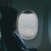 woman looking through airplane windows