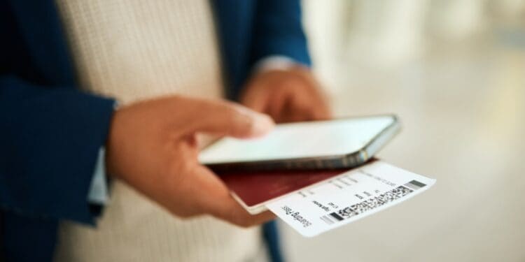 person holding boarding pass and phone